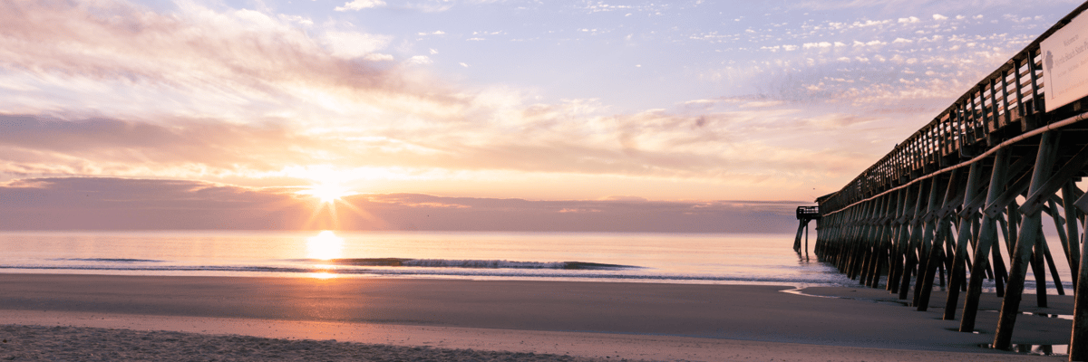 sunset next to a boardwalk in myrtle beach, south carolina