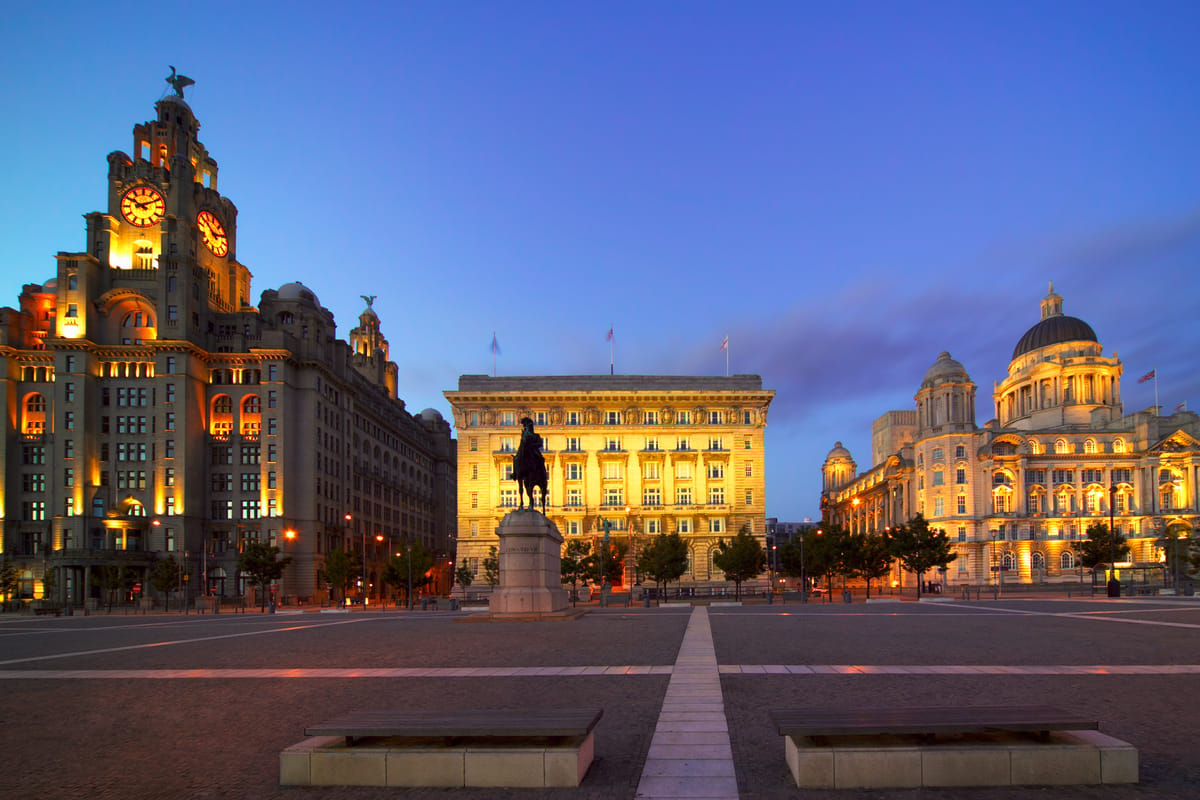 Royal Liver Building and Liverpool Cathedral at dusk, with the equestrian statue of King Edward VII in the foreground. in Liverpool City Centre, UK