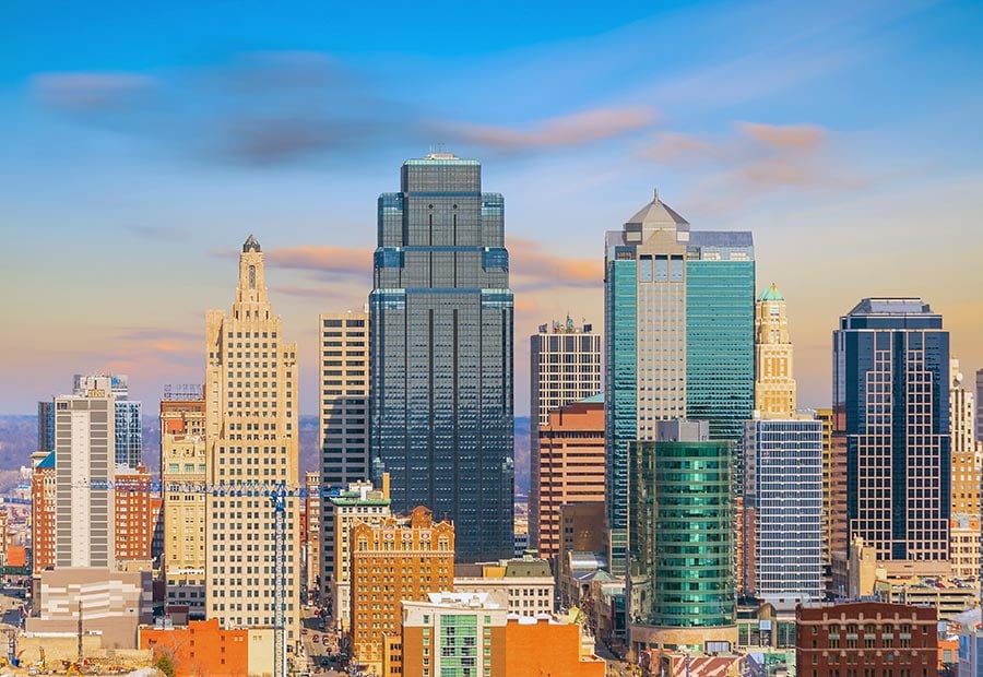 Downtown Kansas City skyline with modern office buildings under a blue sky.