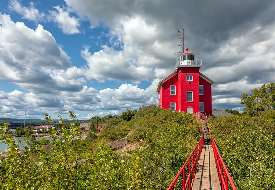 Marquette Harbor Lighthouse on a rocky shoreline overlooking Lake Superior.