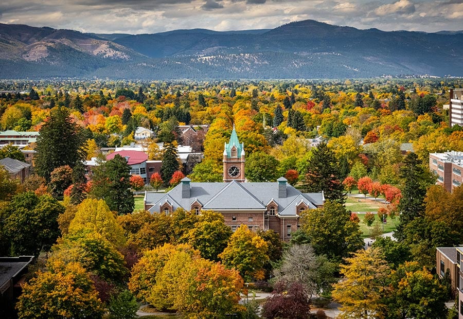 Autumn foliage surrounding the University of Montana campus with mountains in the background.