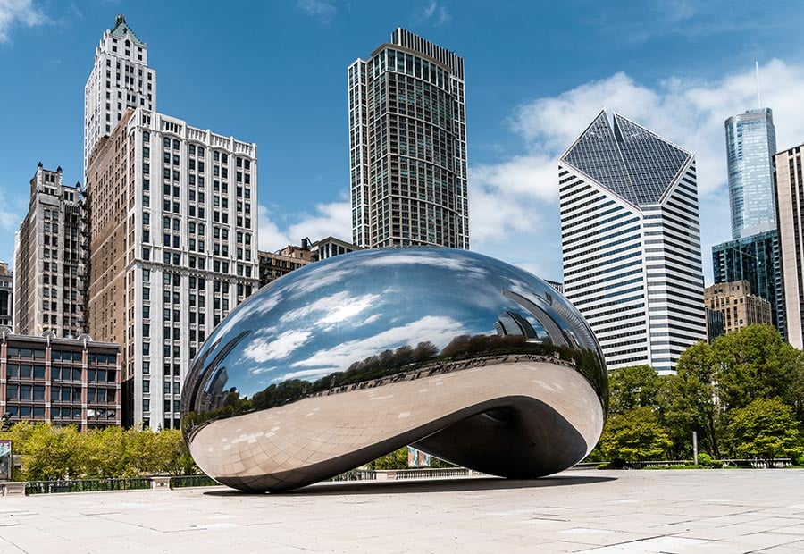 Cloud Gate sculpture in Millennium Park with the Chicago skyline in the background.