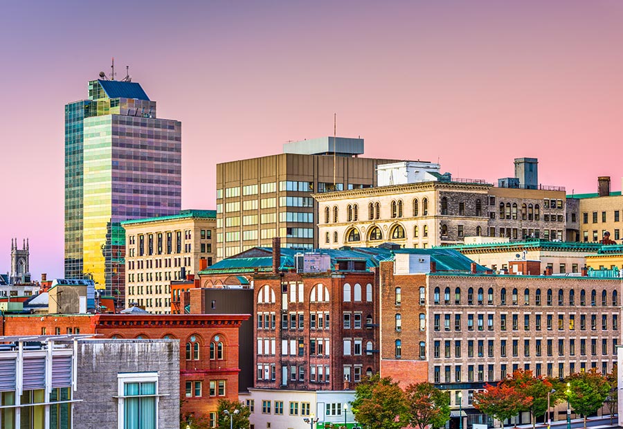 Downtown Worcester skyline with historic brick buildings at sunset.