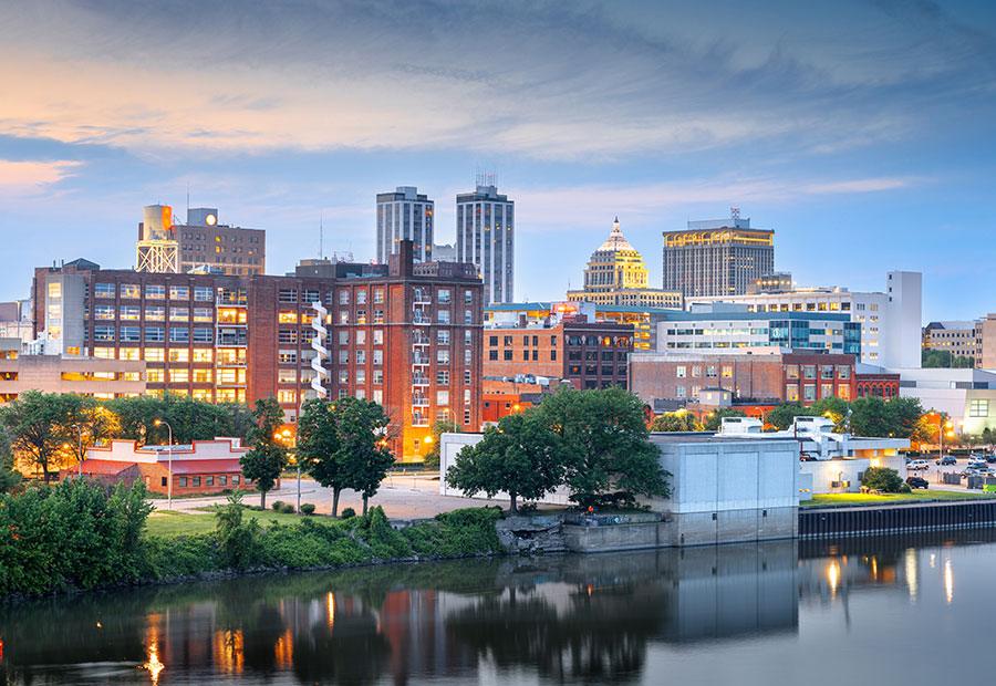 Downtown Peoria skyline along the Illinois River at dusk.
