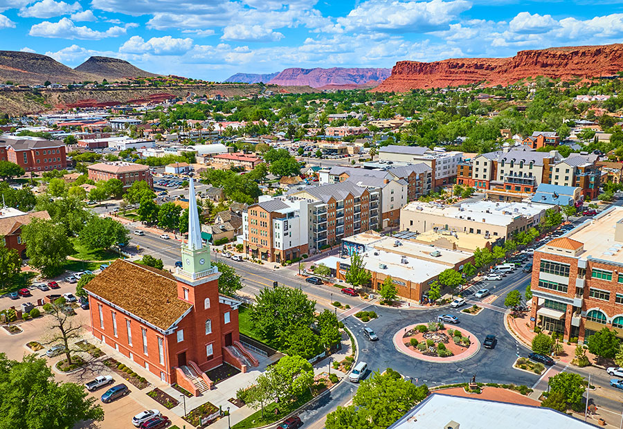 Downtown St. George with red rock cliffs in the background.