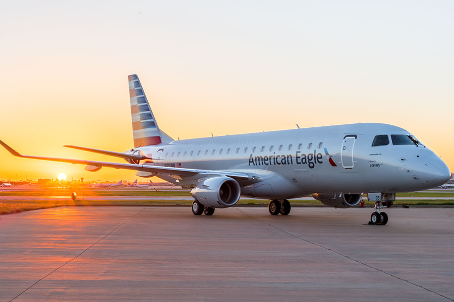 American Eagle aircraft on the tarmac at sunset.