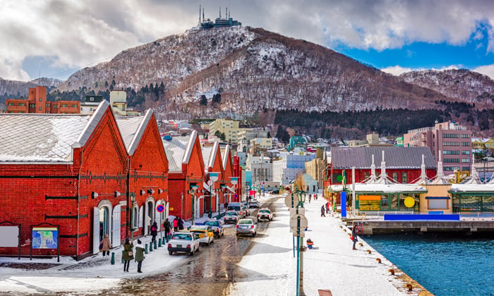 Snowy waterfront and red brick buildings in Japan