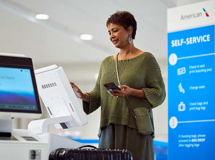 Traveler at self-service kiosk.