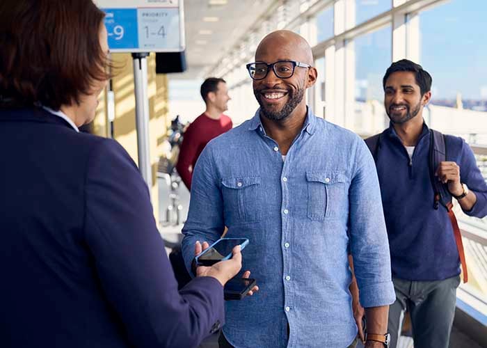 Traveler scanning a mobile boarding pass.