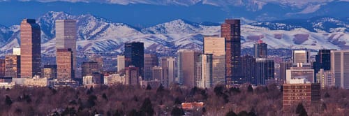 Denver skyline against the backdrop of the Rocky Mountains
