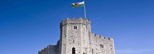 Cardiff Castle in Wales against a bright blue sky