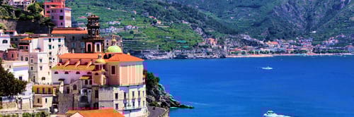 Ascenic view of the Amalfi Coast in Italy, showcasing a picturesque town built into the cliffs overlooking the Mediterranean Sea.