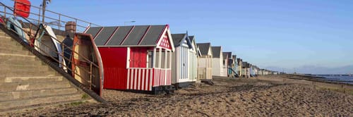 Beach huts at Thorpe Bay in Southend-on-Sea, Essex, England on a sunny day