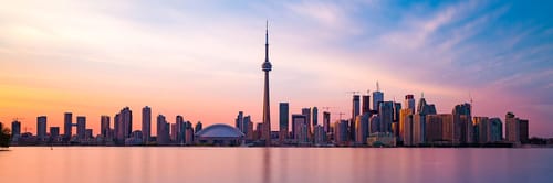 Toronto skyline at sunset including the CN tower and Rogers Centre