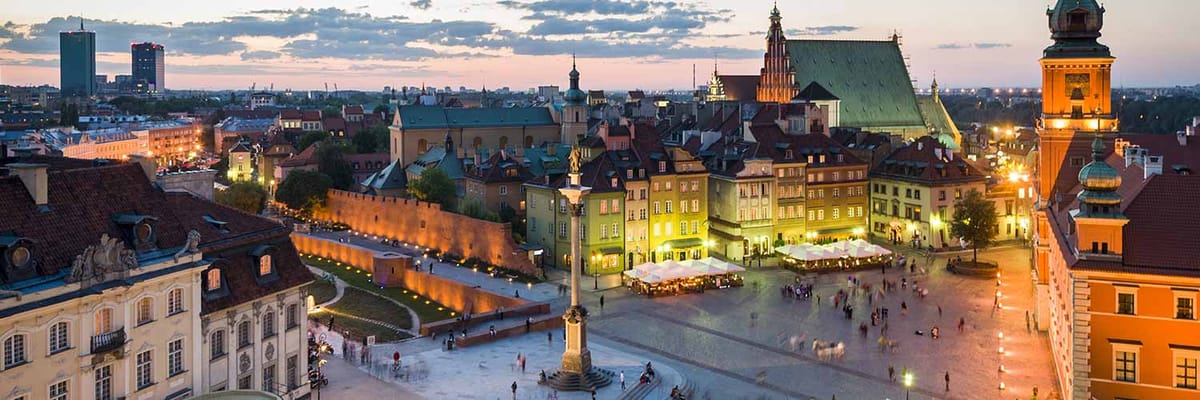 The Old Town Market Square in Warsaw, Poland at dusk.