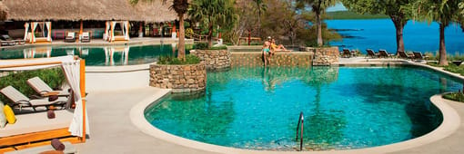 Couple at the main pool at Secrets Papagayo Costa Rica