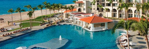 Aerial view of resort exterior and pool at Secrets Puerto Los Cabos Golf & Spa Resort