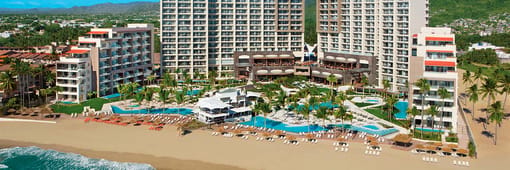 Distant oceanfront aerial view of resort and pools at Dreams Vallarta Bay