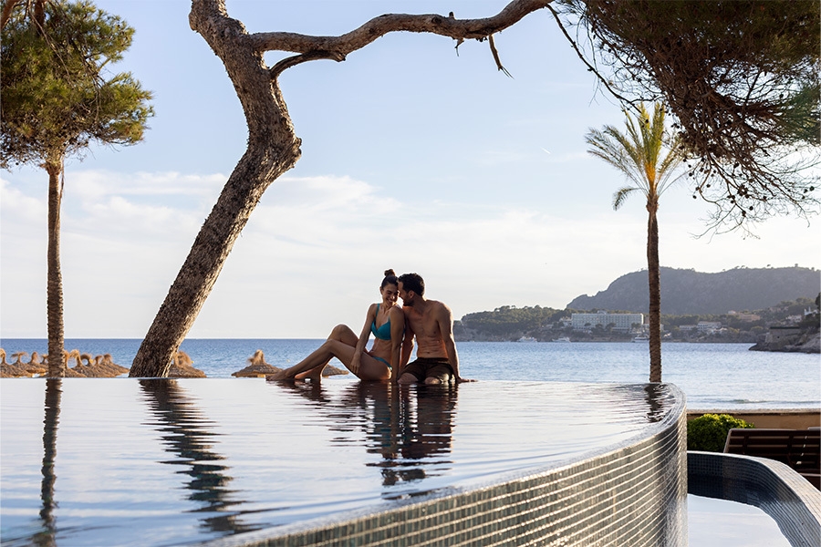 couple resting by the pool enjoying the view