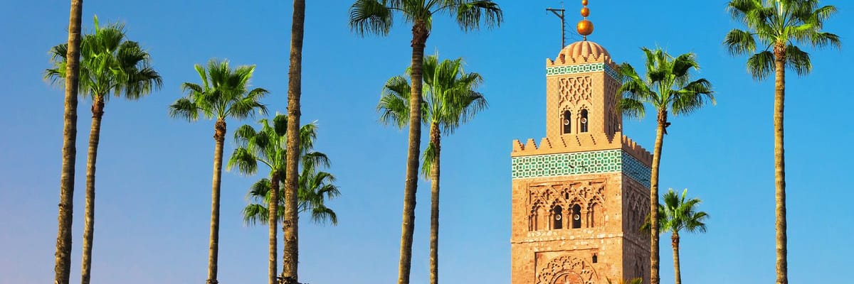 Blue sky, palm trees and a tower in Marrakech