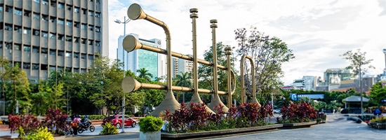 Large trumpet sculptures and open public square at Plaza Jairo Varela in Cali.