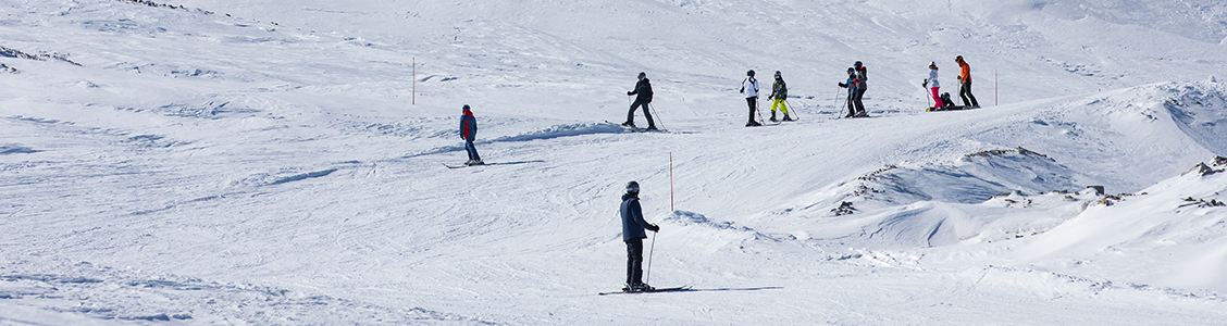 Skier descending snowy mountain