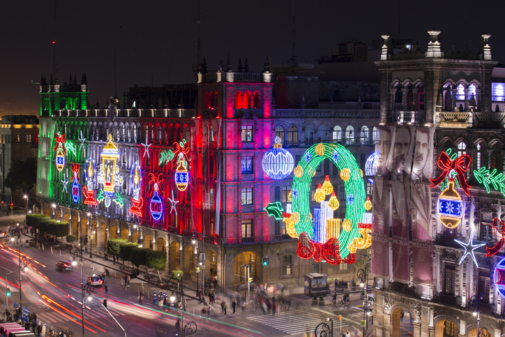 The streets and buildings of Mexico’s city center illuminated with neon lights at Christmas. 