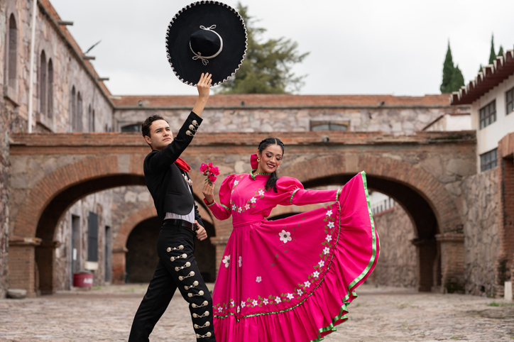 A couple of dancers dressed in typical mexican costumes in the streets of Guadalajara.