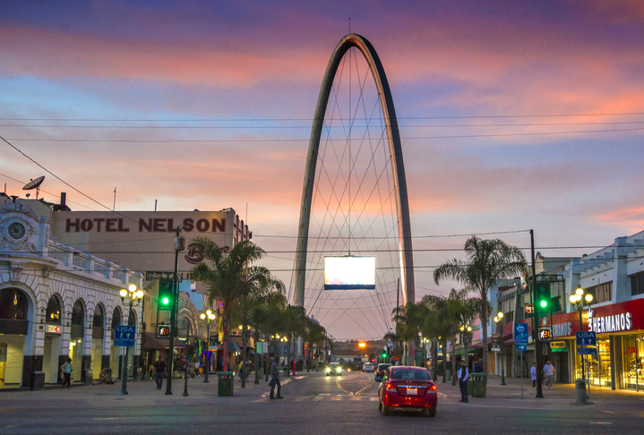 Avenida Revolución en Tijuana con el famoso arco monumental al fondo al caer la tarde.