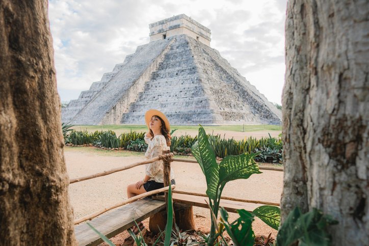 A female tourist exploring Chichen Itzá.