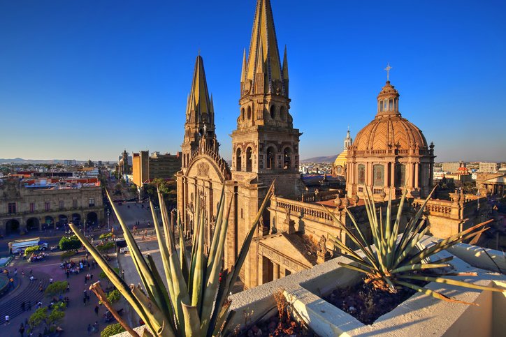 Aerial view of Nuestra Señora de Guadalajara Church and the city center at sunset.
