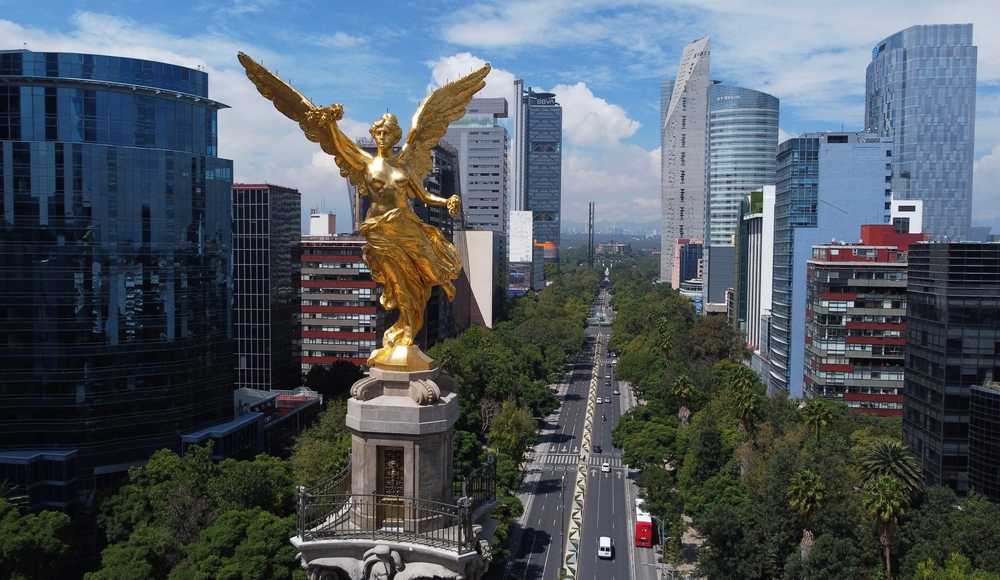 Aerial view of Mexico City skyline at Plaza de la Reforma, with the Angel of Independence statue in the front.