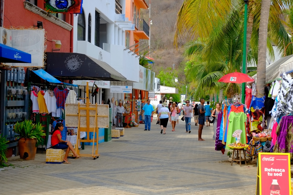 People strolling on a commercial street in the city center, Huatulco.