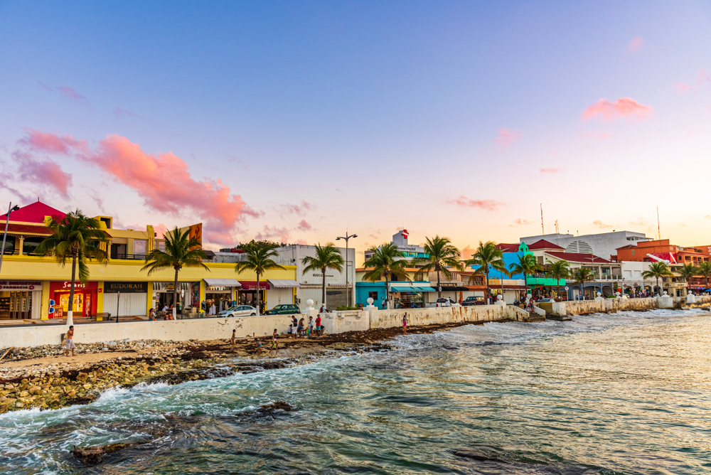 Colorful buildings and palm trees in the streets of San Miguel de Cozumel.