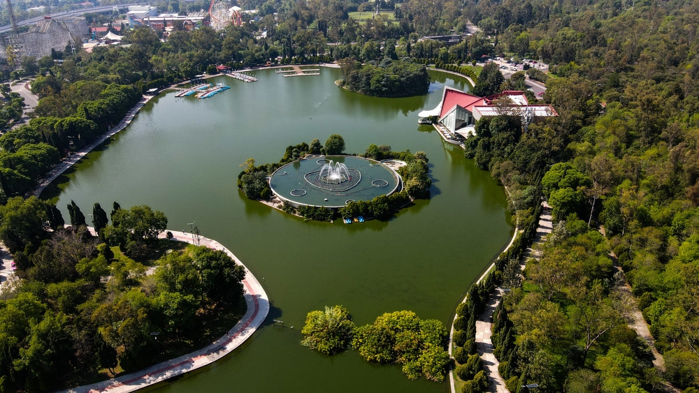 Aerial views of Lake Mayor in Chapultepec Park, showing the fountain, the Audiorama and the surrounding tree-lined walkways in Mexico City.