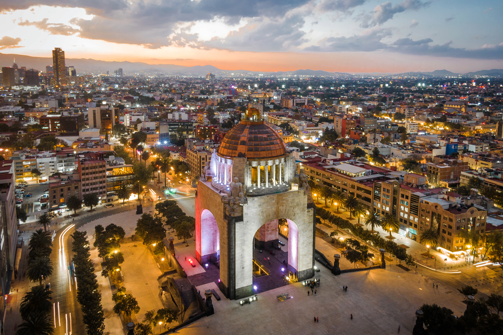 Aerial view of the city center showing the famous architectural landmark Monument to the Revolution located in Plaza de la República at dusk in Mexico City, Mexico.