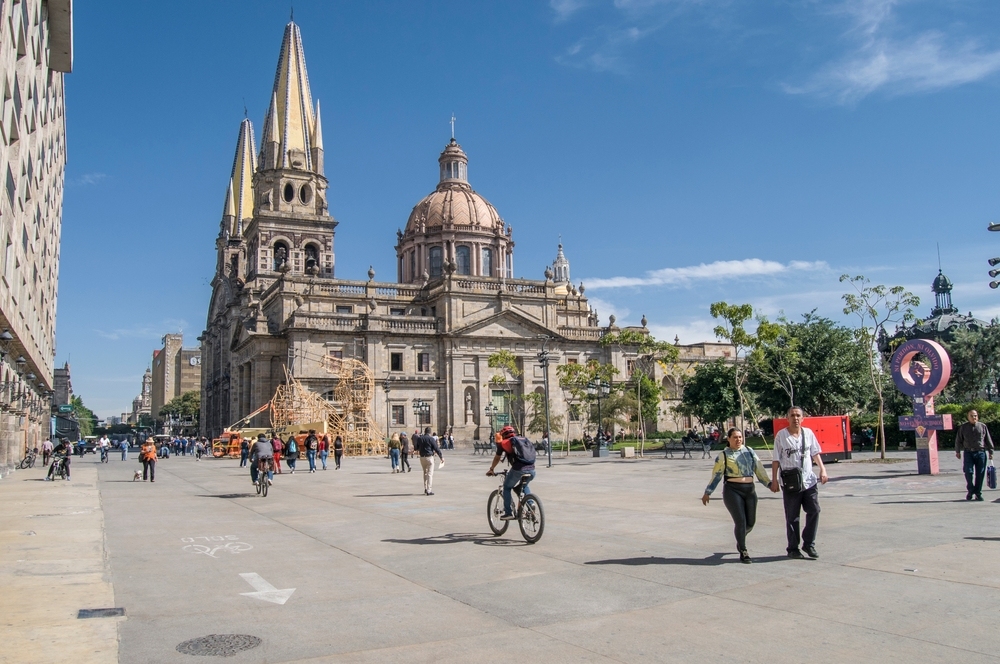 People walking in the main square near the Cathedral on a sunny day to enjoy the holidays.