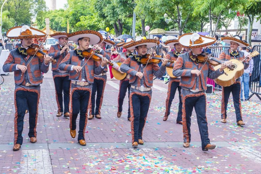 A group of musicians playing mariachi on the streets of Guadalajara during a celebration.