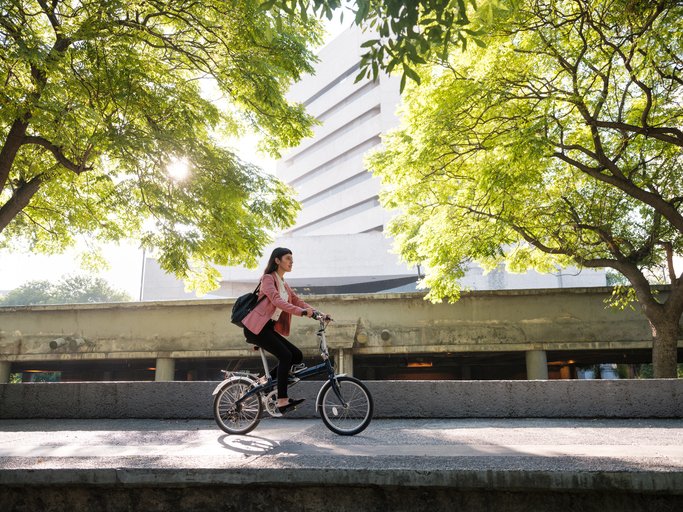 A woman biking across the streets of Monterrey.