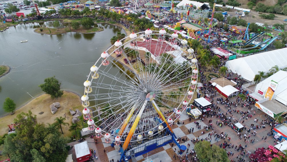 Aerial view of San Marcos Fair, with a ferris wheel and people walking.
