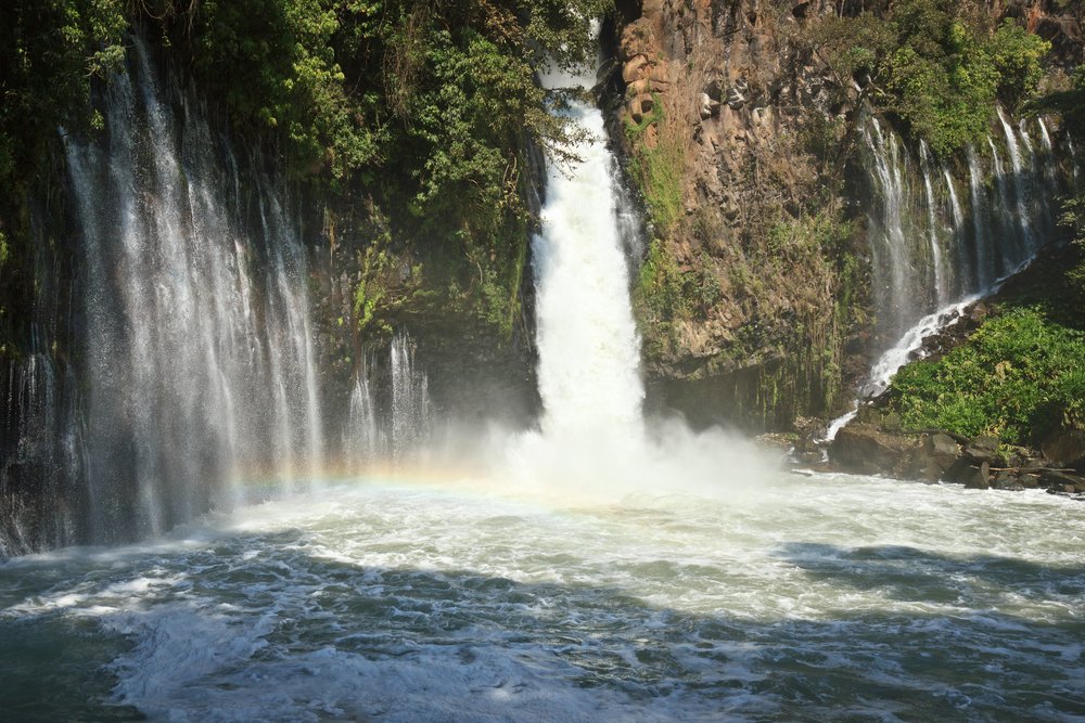 A rainbow crossing through Tzaráracua Waterfall, near Uruapan.