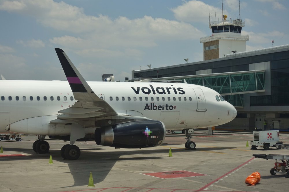 The front of Volaris airbus “Alberto” parked at the airport.