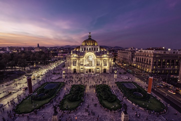 Aerial view of Mexico City’s historic center at night, with Alameda Central Park, the Palacio de Bellas Artes and surrounding buildings.