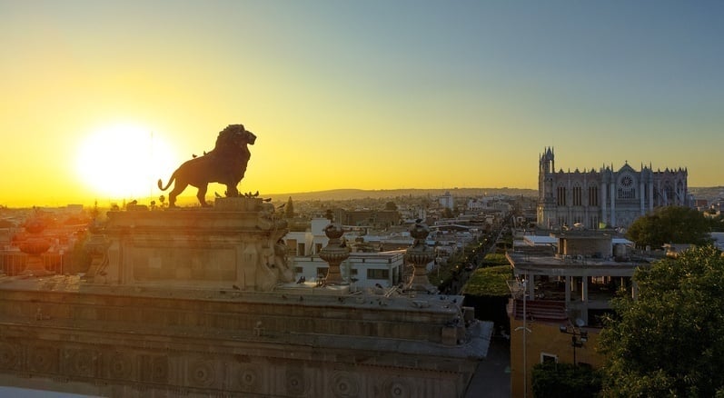 Aerial view of Leon’s city center and its iconic sculpture at sunset.