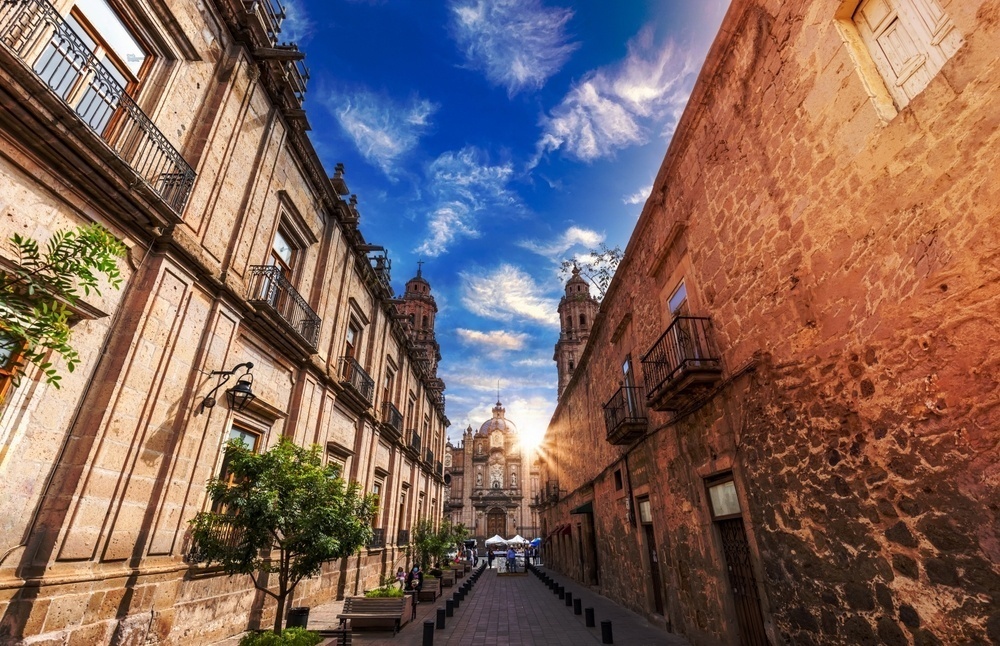 Colonial buildings of Morelia and a street leading to Plaza de Armas, with the Cathedral in the background.