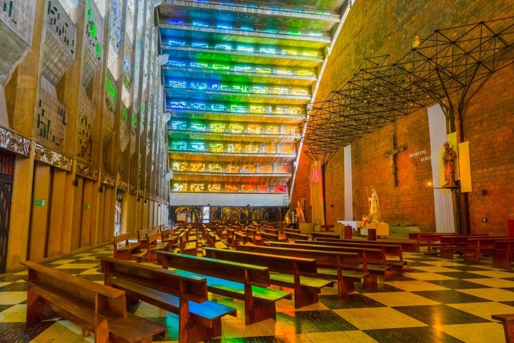 Interior of El Rosario Church, with its multicolor vitral walls.