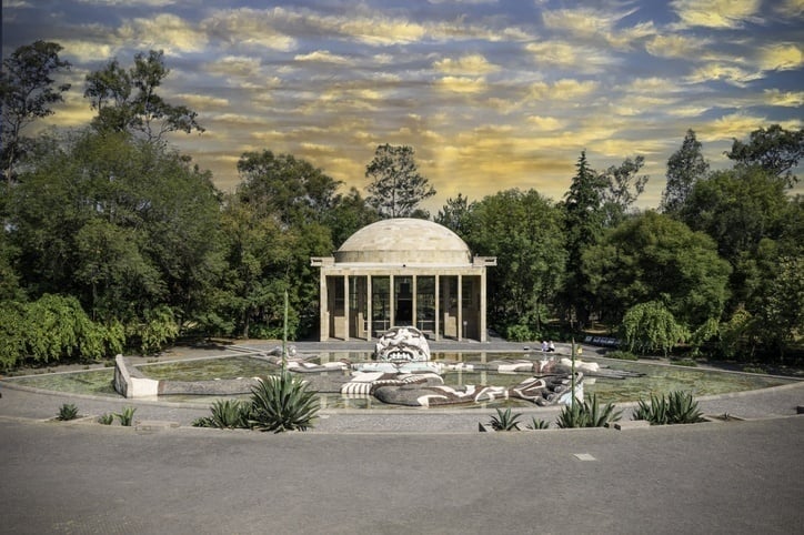 Tláloc Fountain, an iconic Mexican cultural symbol, within the lush greenery of Chapultepec Forest.