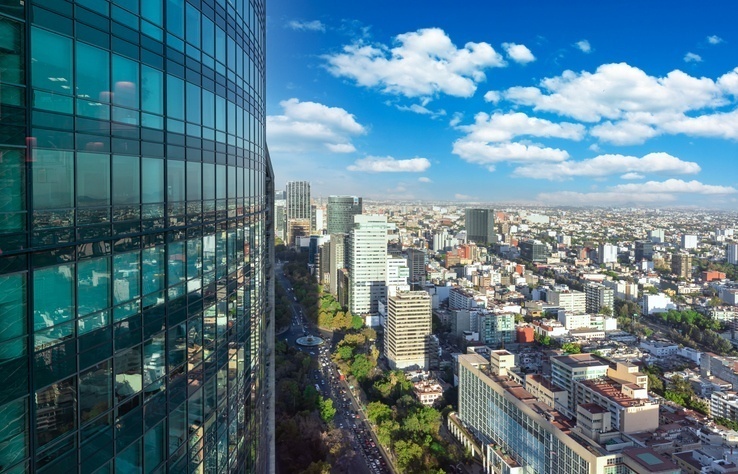 Aerial view of Mexico City, skyscrapers and Chapultepec forest.