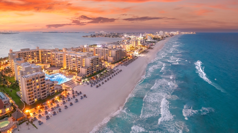 Aerial view of Cancun Hotel Zone beachshore at sunset.