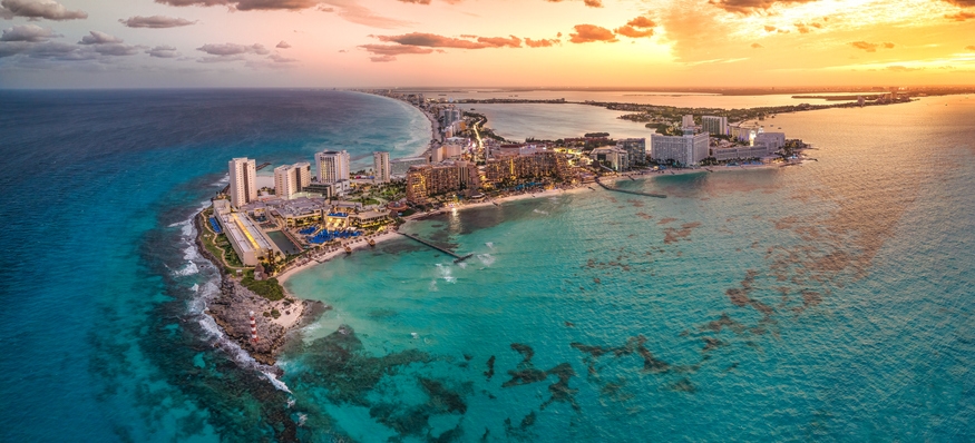 Aerial view of Cancun Hotel Zone beachshore at sunset.